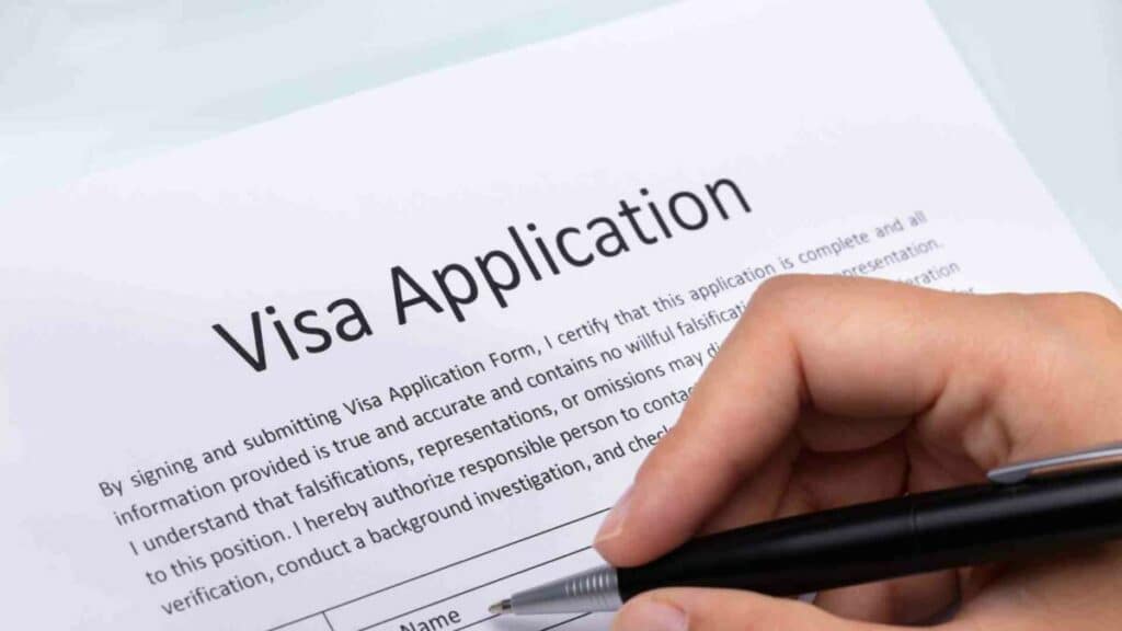 A business owner filling a visa application document required