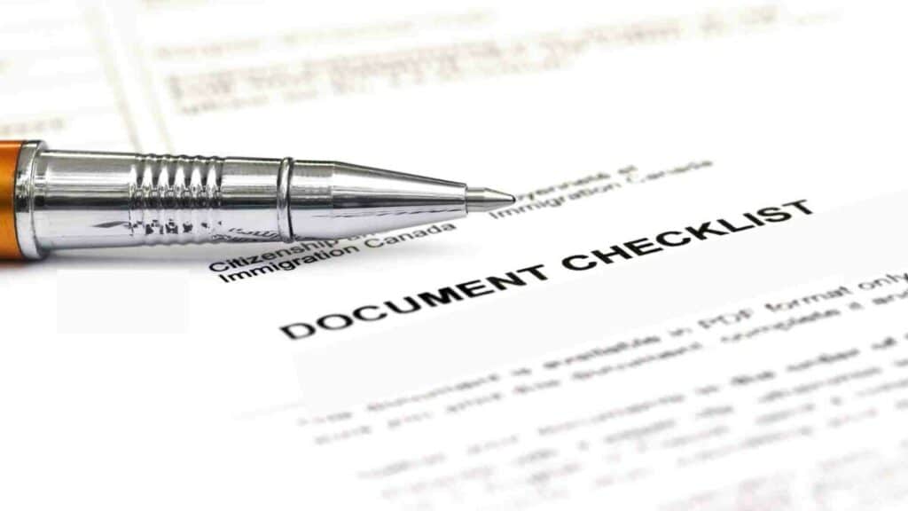 E1 visa requirements visa checklist with a pen