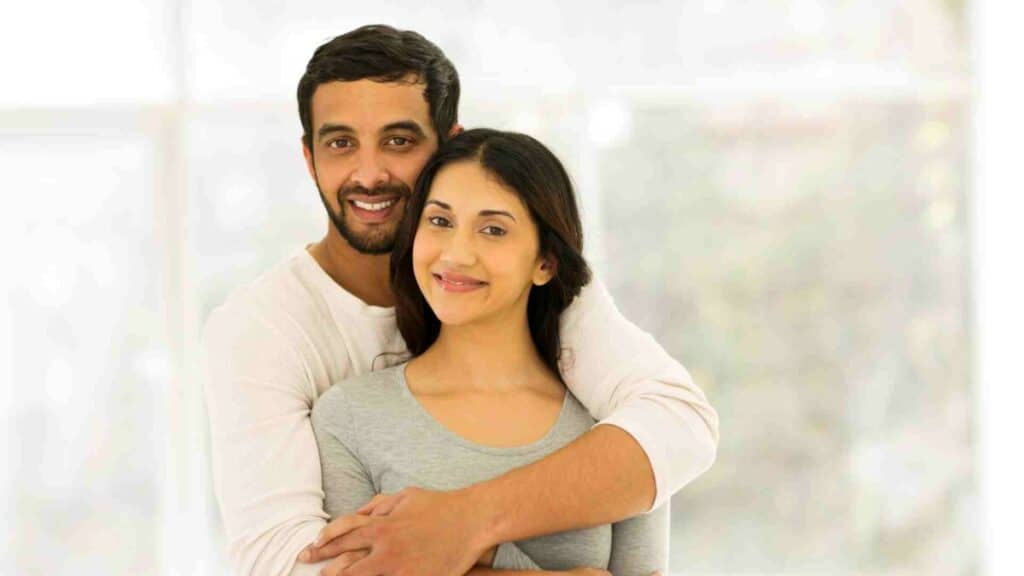 An indian man hugging his wife in a house in America