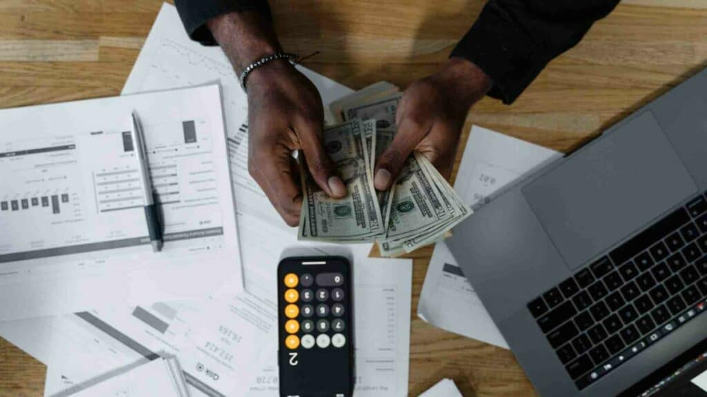 An entrepreneur calculating money for E2 visa business loans