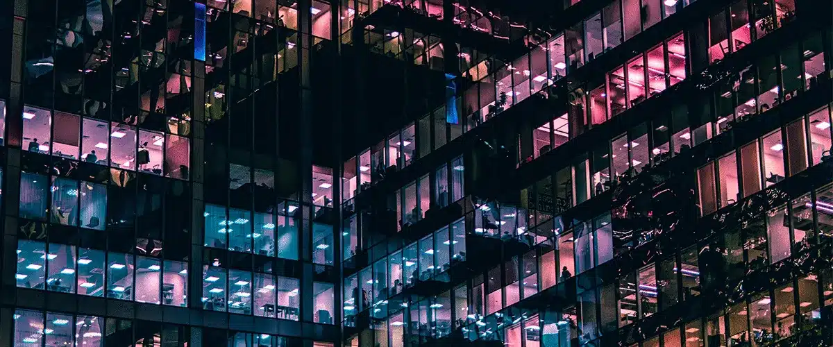 Office building windows lit up at night