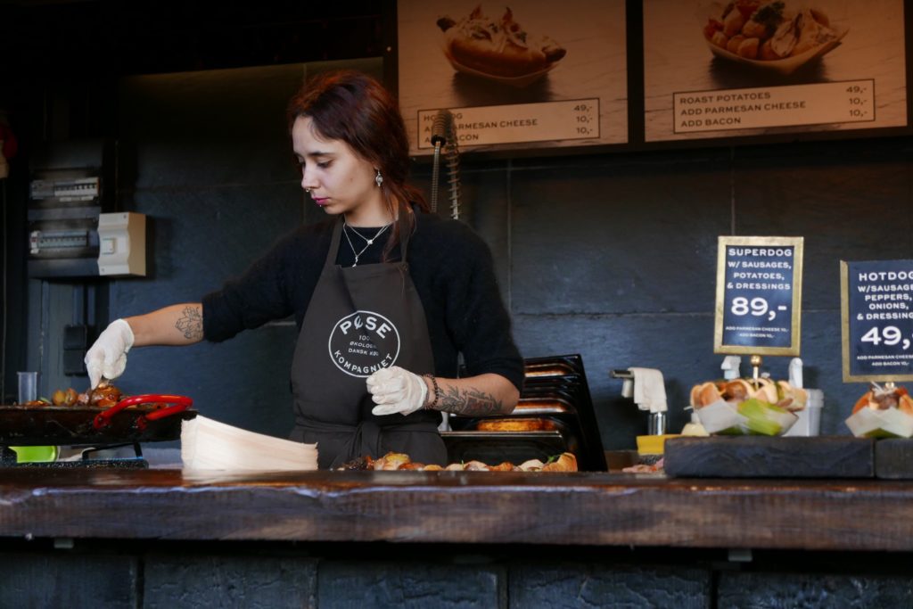 A woman in front of a live kitchen